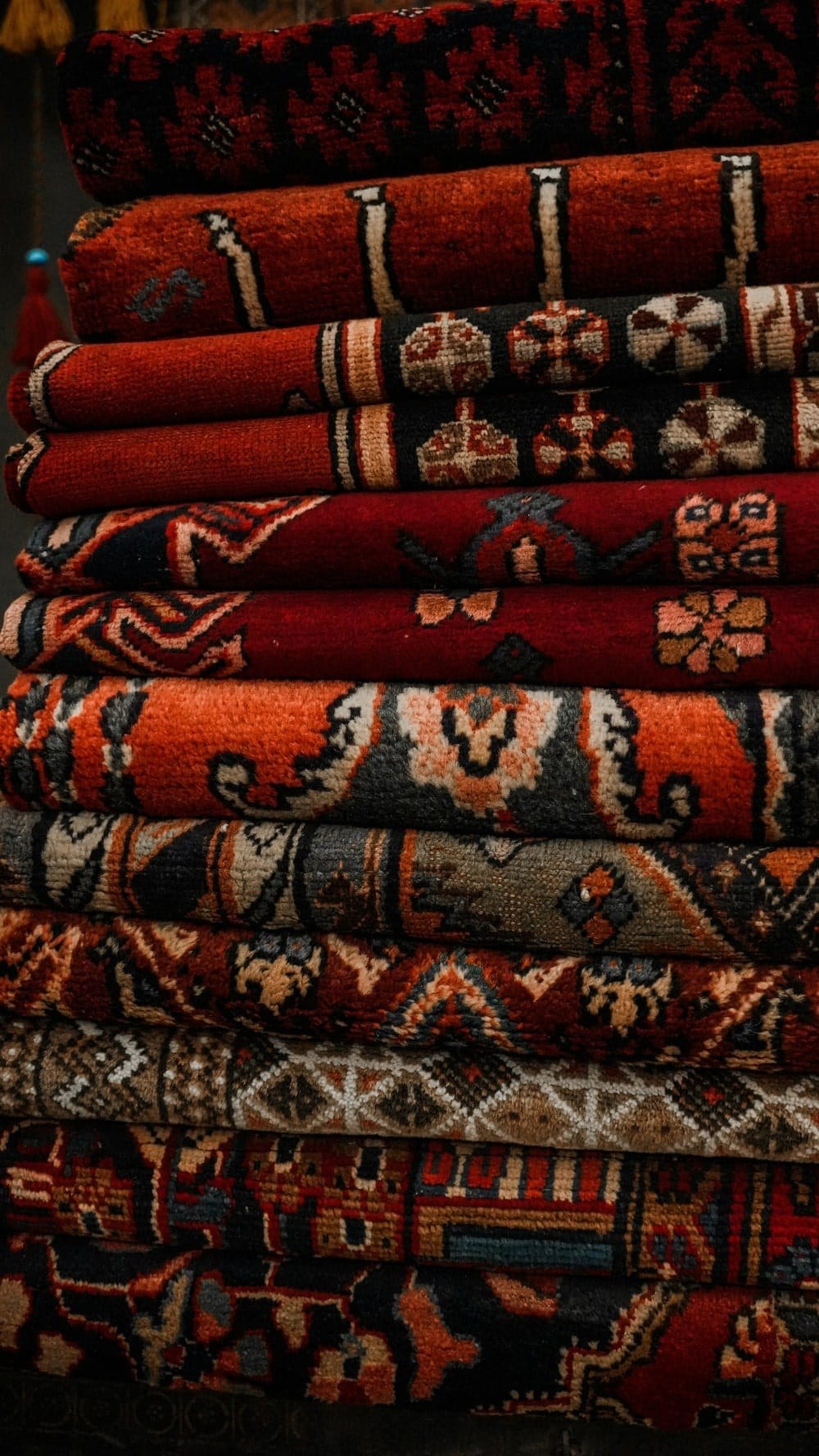 Cleaned handmade rugs stacked and ready to return